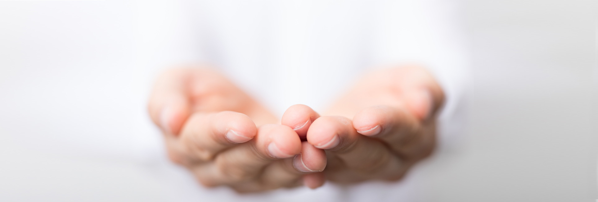 Hands representing the give gester on a washed out gray and white background