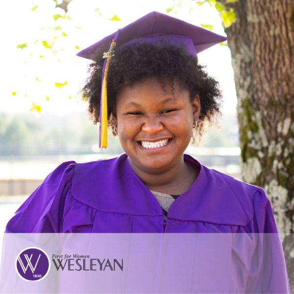 Caiara Bradley, a smiling graduate wearing a purple cap and gown, with the Wesleyan College logo in the bottom left corner. 