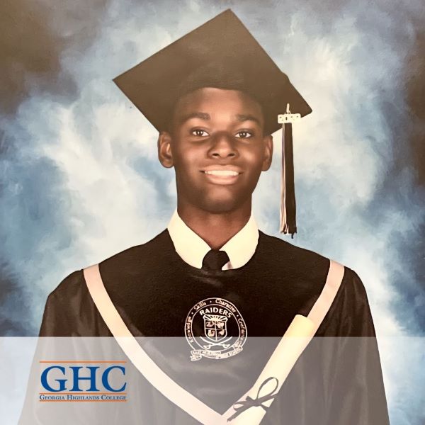 Cameron King, a graduate wearing a cap and gown, with the Georgia Highlands College logo in the bottom left corner.