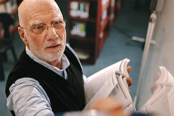 Man writing on white board
