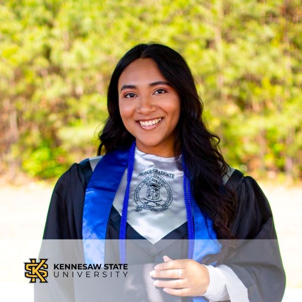 Jamie Escalona, a student in a graduation gown, with the Kennesaw State University logo in the bottom left corner.
