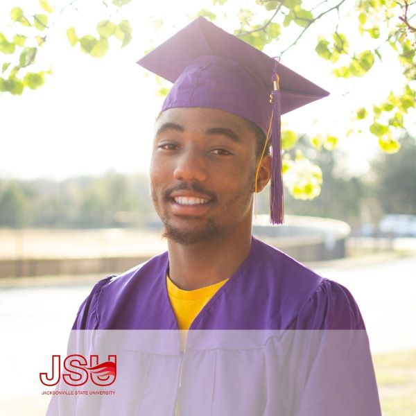 Justin Harewood, a graduate wearing a purple cap and gown with the Jacksonville State University logo in the bottom left corner.