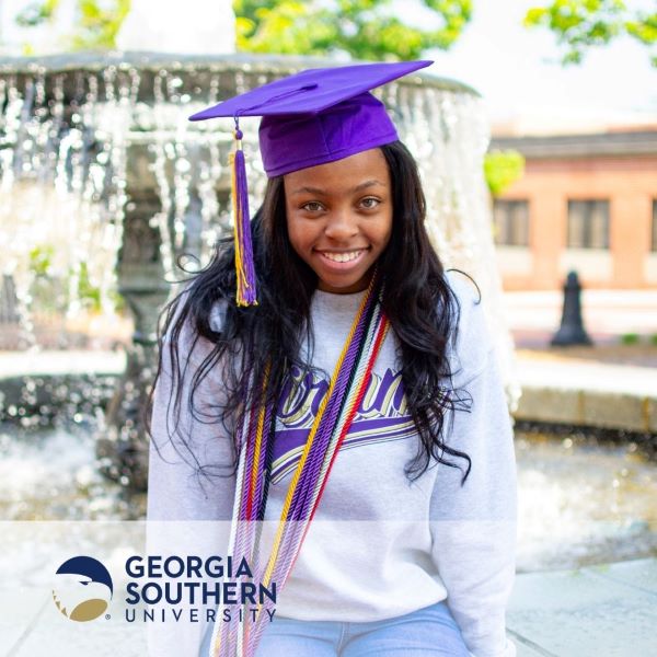 Kennedy Alexander, a graduate wearing a purple cap and the Georgia Southern University logo in the bottom left corner.