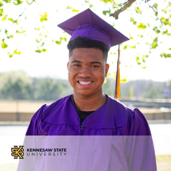 Kylan Fleming, a graduate wearing a purple cap and gown with the Kennesaw State University logo in the bottom left corner.