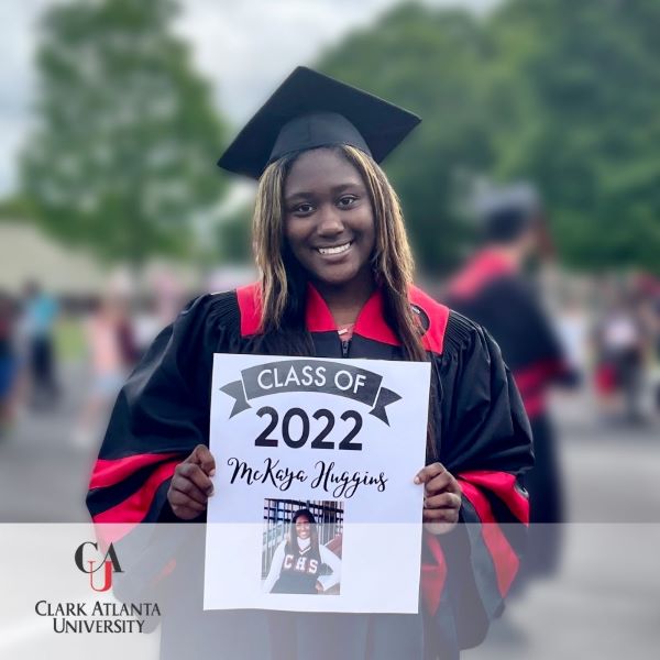 McKaya Huggins, a graduate wearing a cap and gown, with the Clark Atlanta University logo at the bottom left corner.