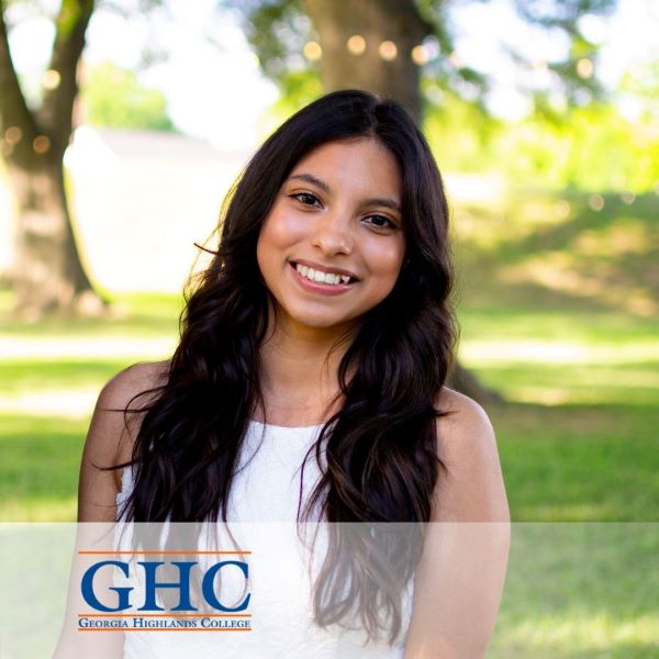 Noelia Escutia, smiling in a headshot in an outdoor setting, with the Georgia Highlands College logo in the bottom left corner.