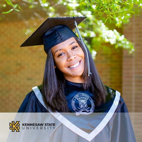 Nyla Hines, a graduate wearing a cap and gown with the Kennesaw State University logo in the bottom left corner.