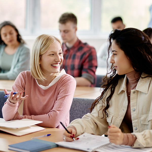 classroom with 2 women talking at their desk