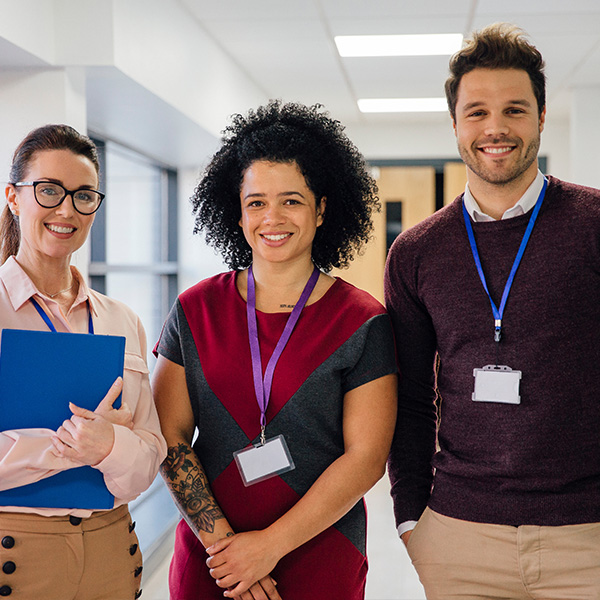3 teachers standing in hall 