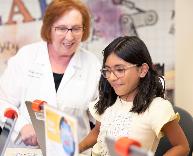 A teacher and young student work together on a STEM project