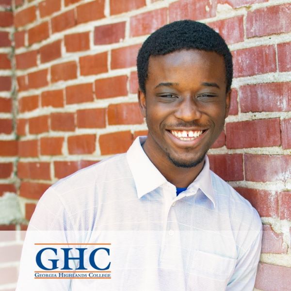 Y'van Haden Ngah, a smiling student leaning against a brick wall, with the Georgia Highlands College logo in the bottom left corner.