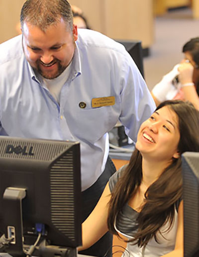 teacher and student at computer