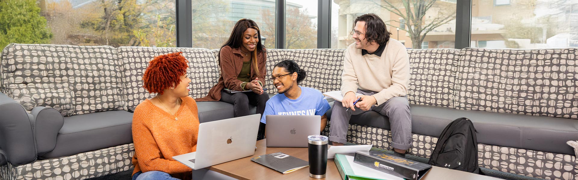 group of ksu students lounging and collaborating with eachother.