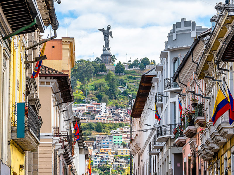 A vibrant street scene in Ecuador featuring buildings and flags, representing the International Student Teaching Study Abroad program.