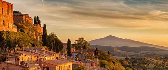 A picturesque sunset casts vibrant hues over the town of San Giovanni, creating a serene study abroad atmosphere.