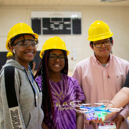 students in gym with drone