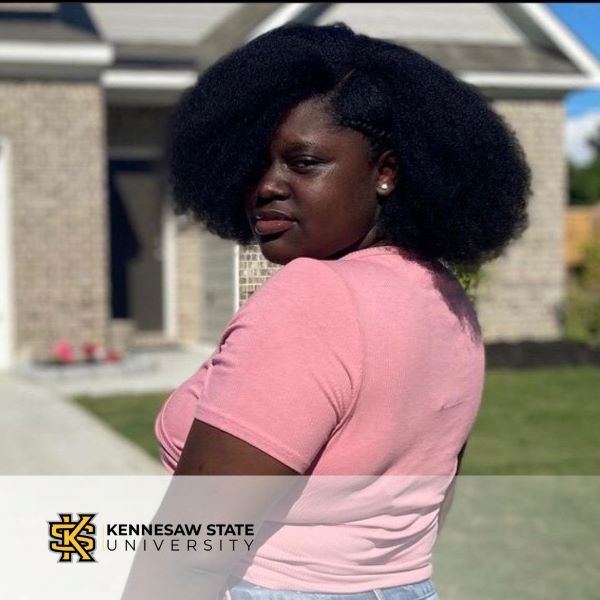Angel Agyapong, in a headshot in an outdoor setting with the Kennesaw State University logo in the bottom left corner.