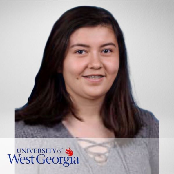 Dania Alvarado, smiling in a headshot with a neutral background and the University of West Georgia logo in the bottom left corner.