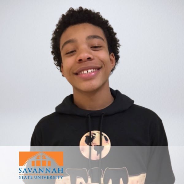Joshua Lee, smiling in a headshot with a neutral background.
