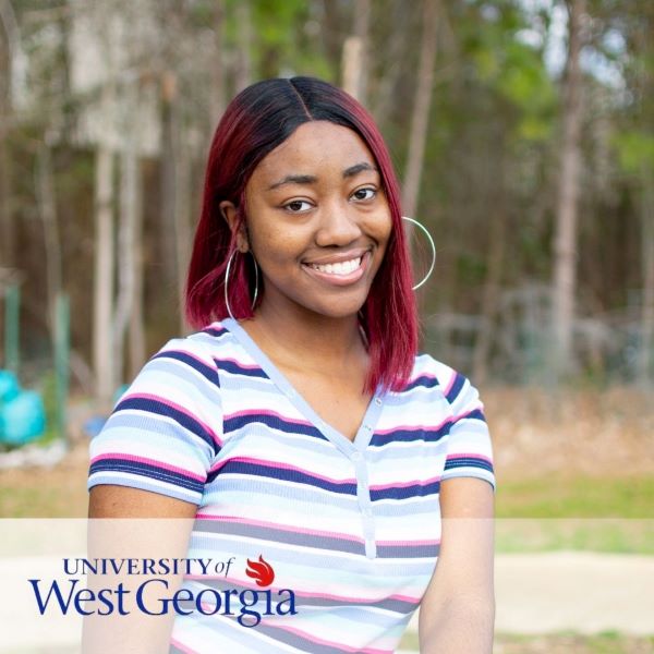 Katriece Callier, smiling in an outdoor setting.