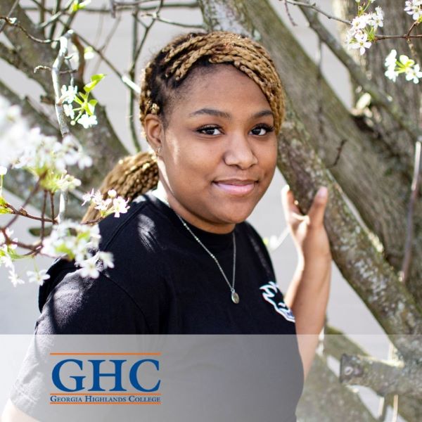 Laila Hoffman, standing near a tree with the Georgia Highlands College logo in the bottom left corner.