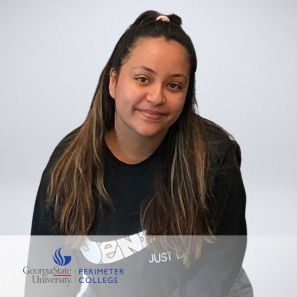 Marisca Avina, smiling in a headshot in a neutral background.