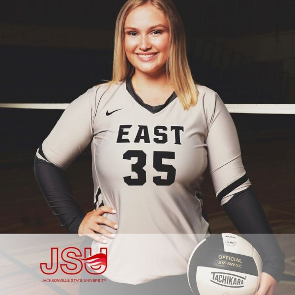 Peyton Brantley, smiling and dressed in a sports uniform, holding a ball.
