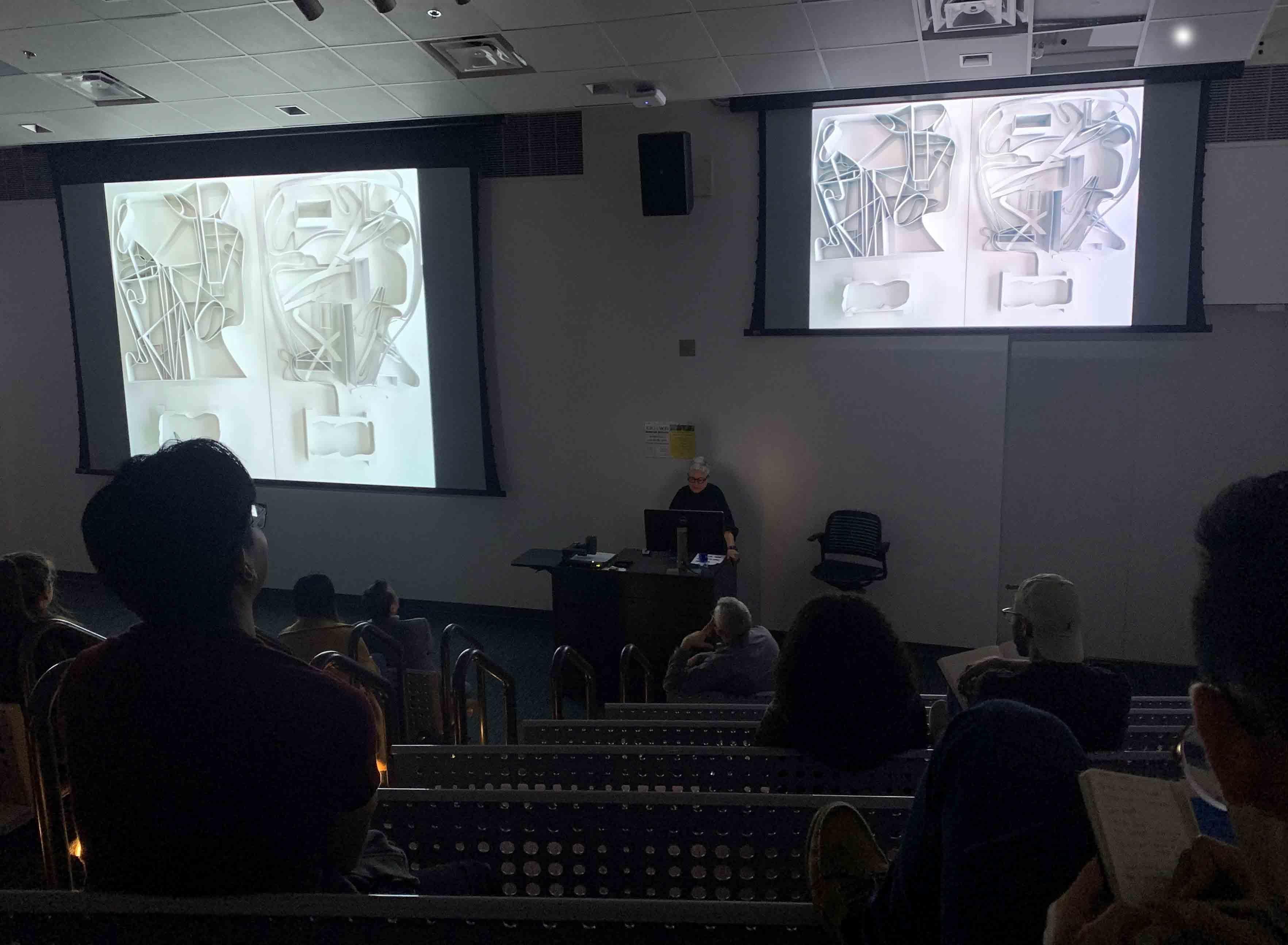  / Merrill Elam giving a presentation on a large screen  