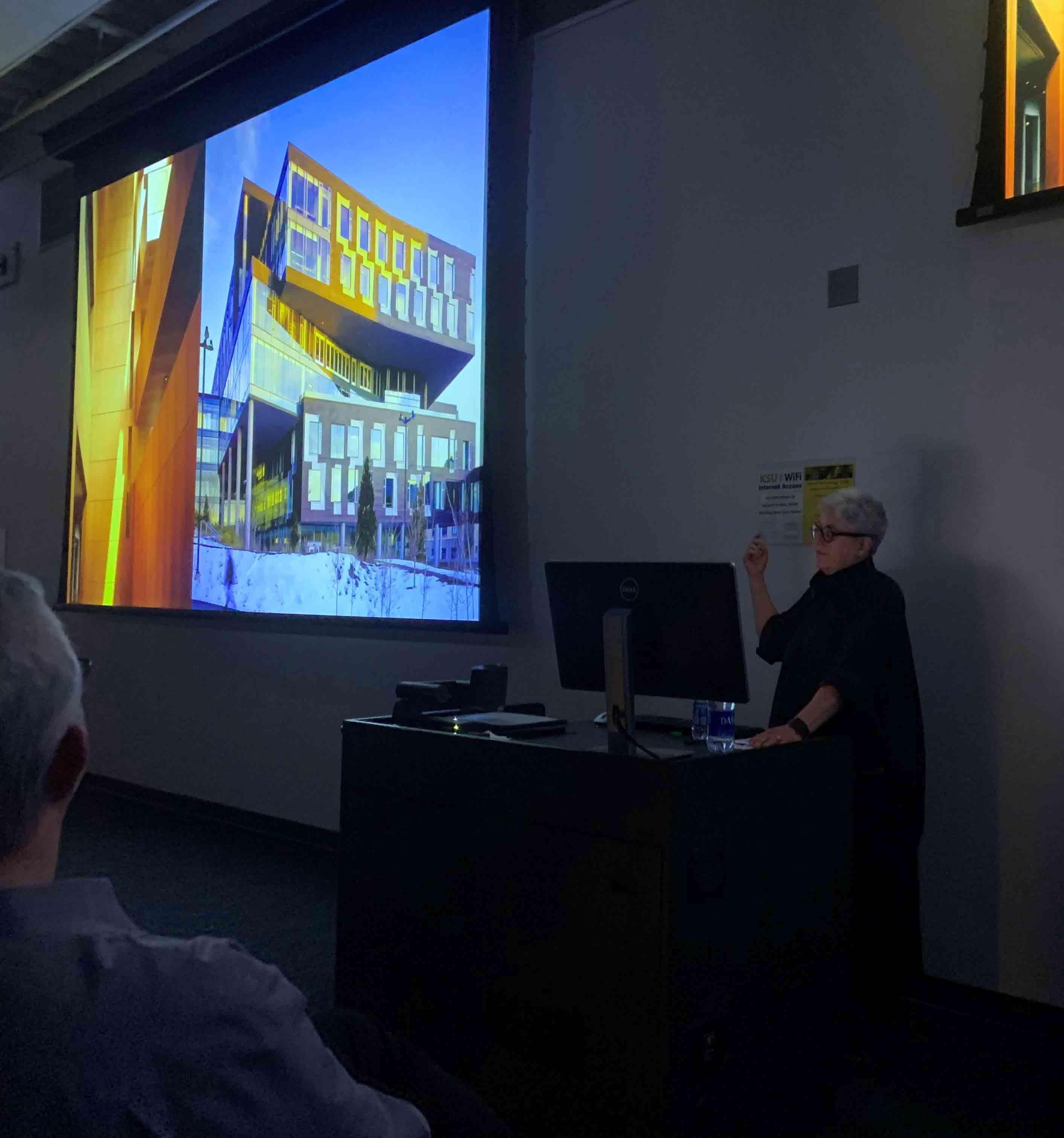  / Merrill Elam giving a presentation on a large screen  