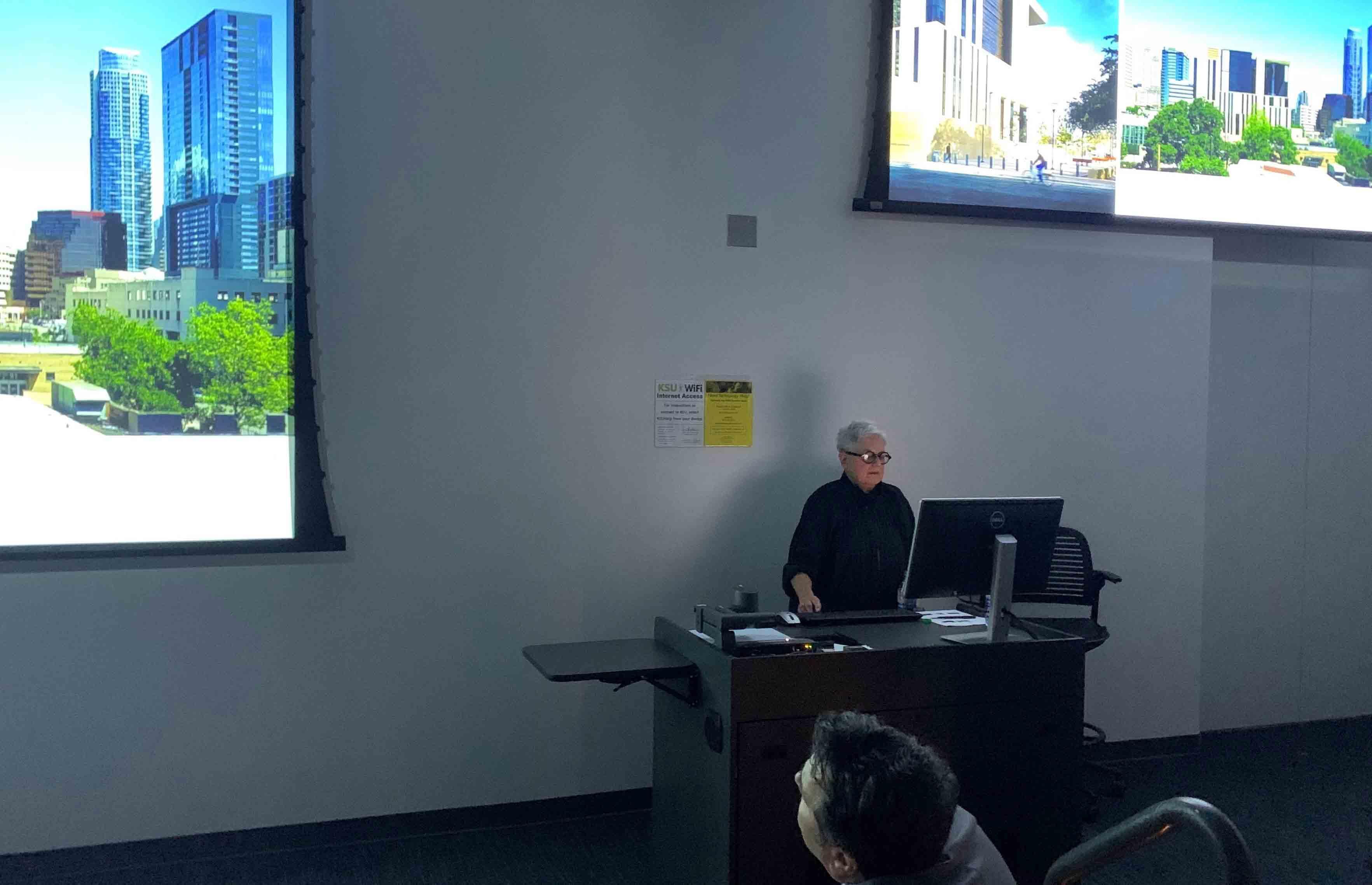  / Merrill Elam standing at a desk 