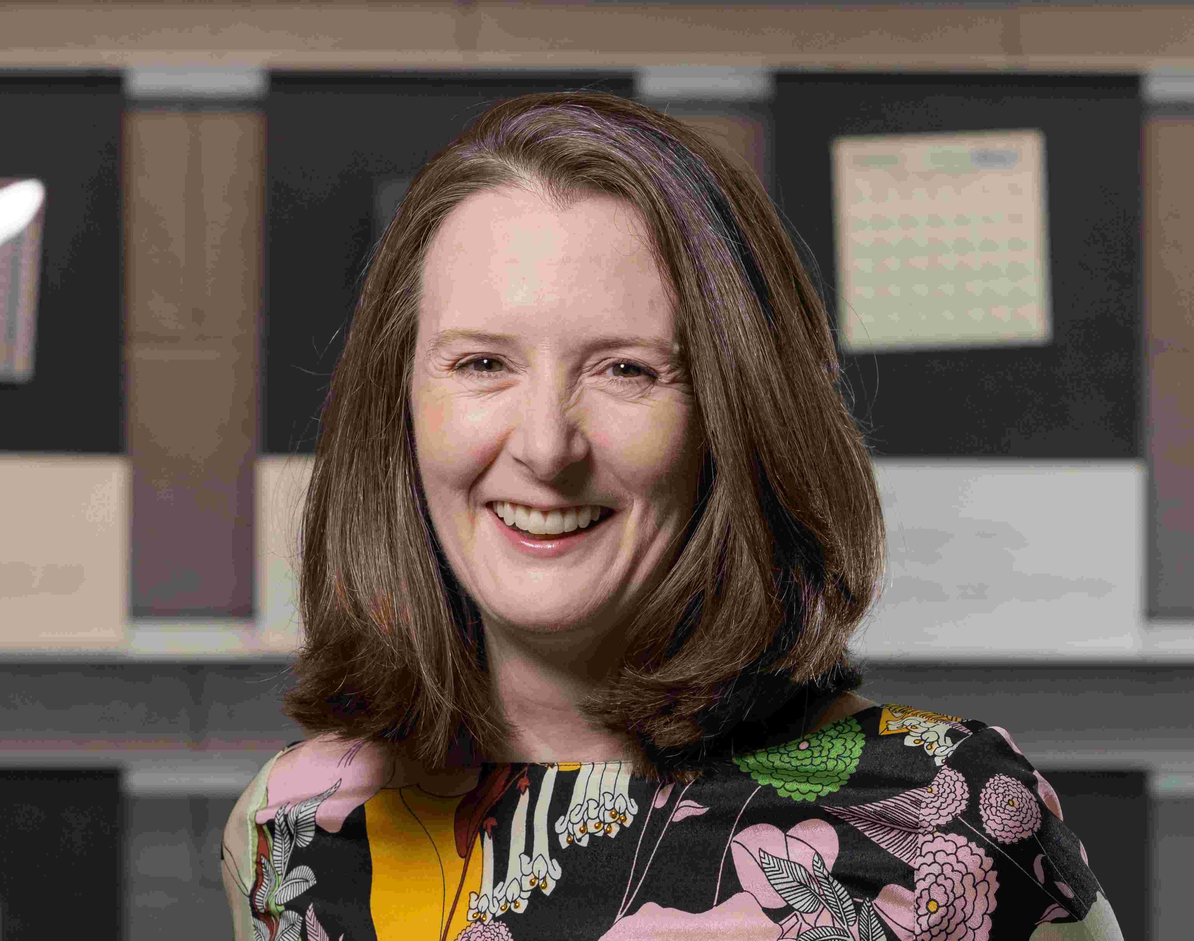 Kathryn Bedette smiling in the Materials Lab. 