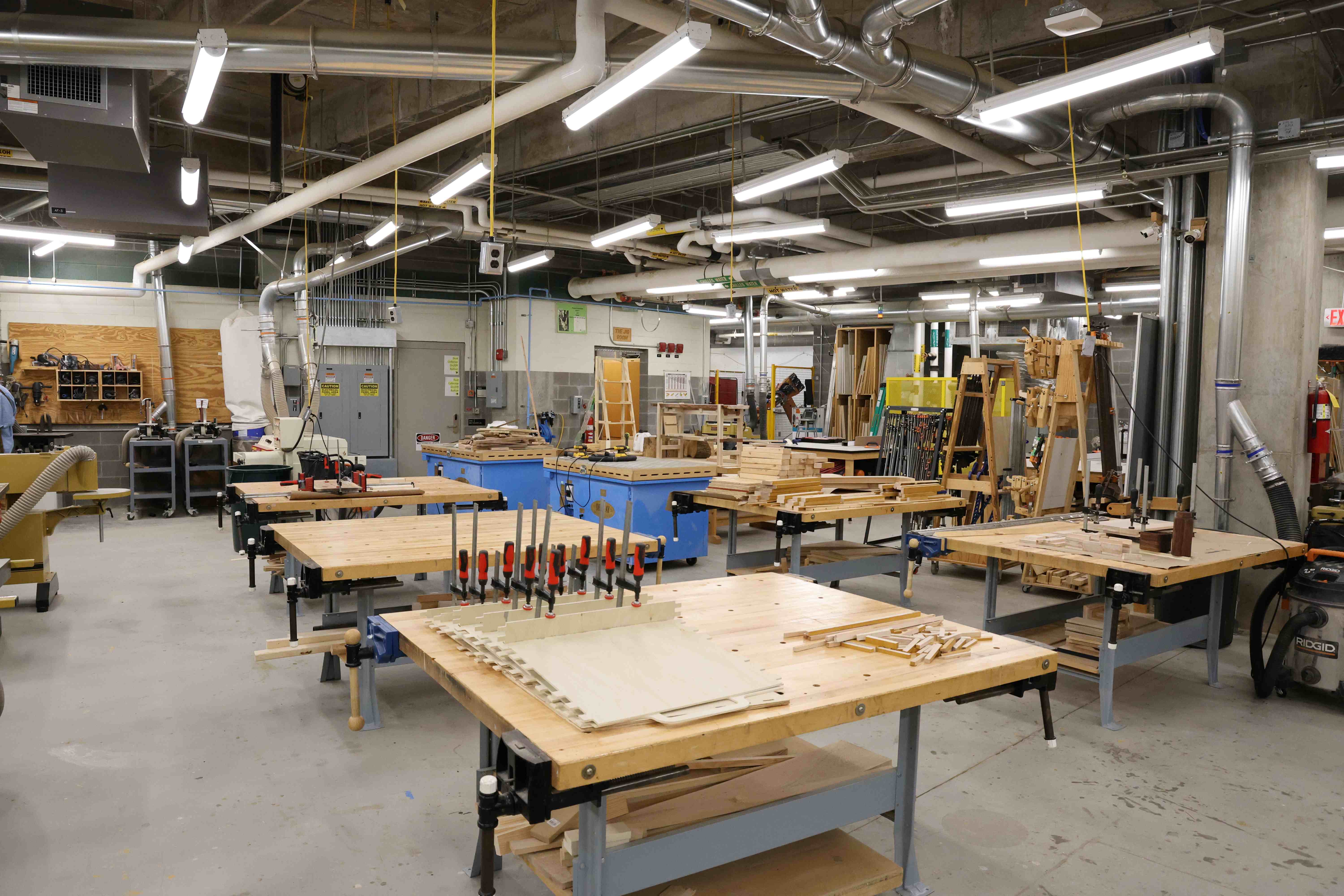 An expansive woodshop with various materials and tools.
