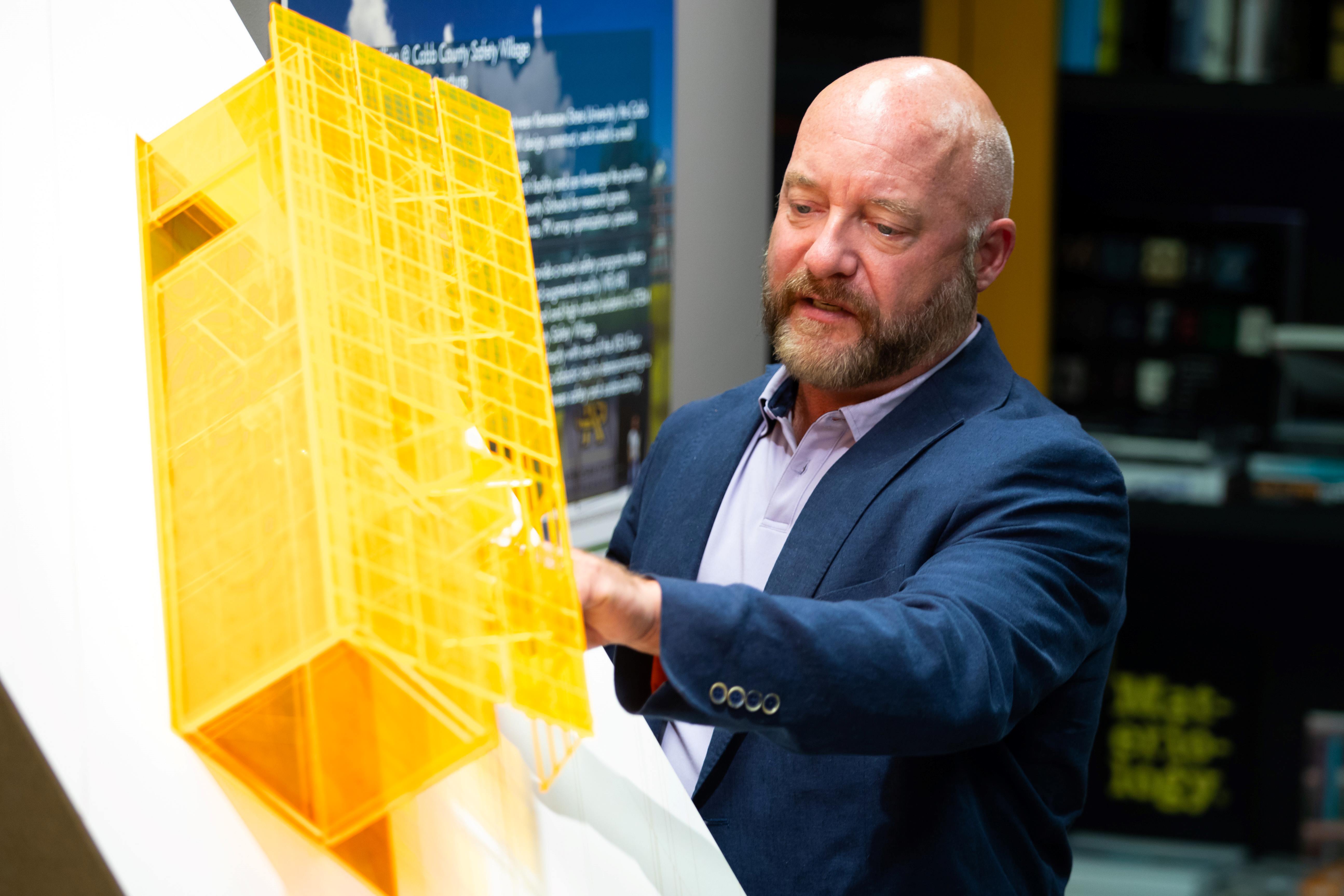 Professor Michael Carroll presenting the KSU Mini Pavilion model.