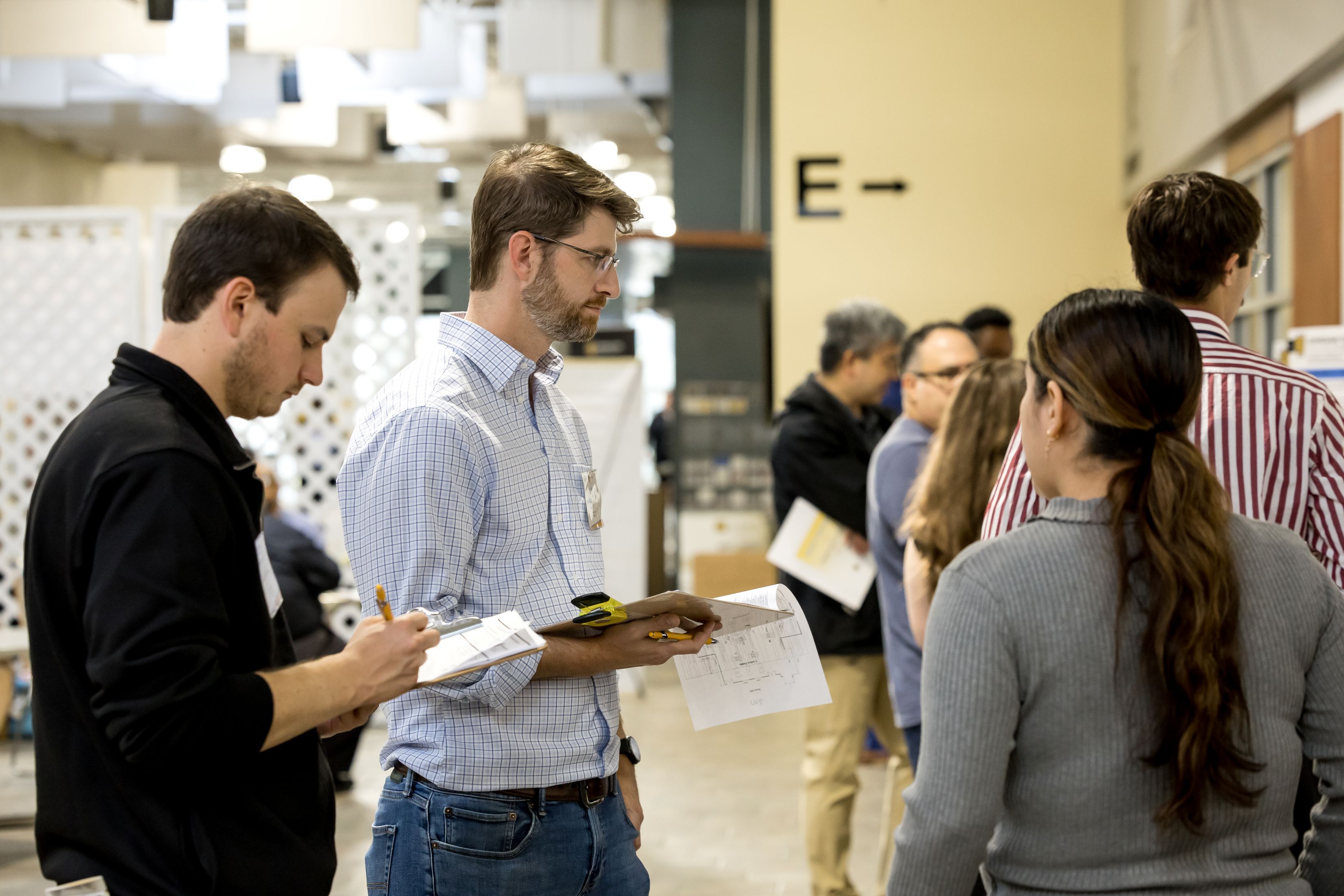 Two judges looking at a students poster