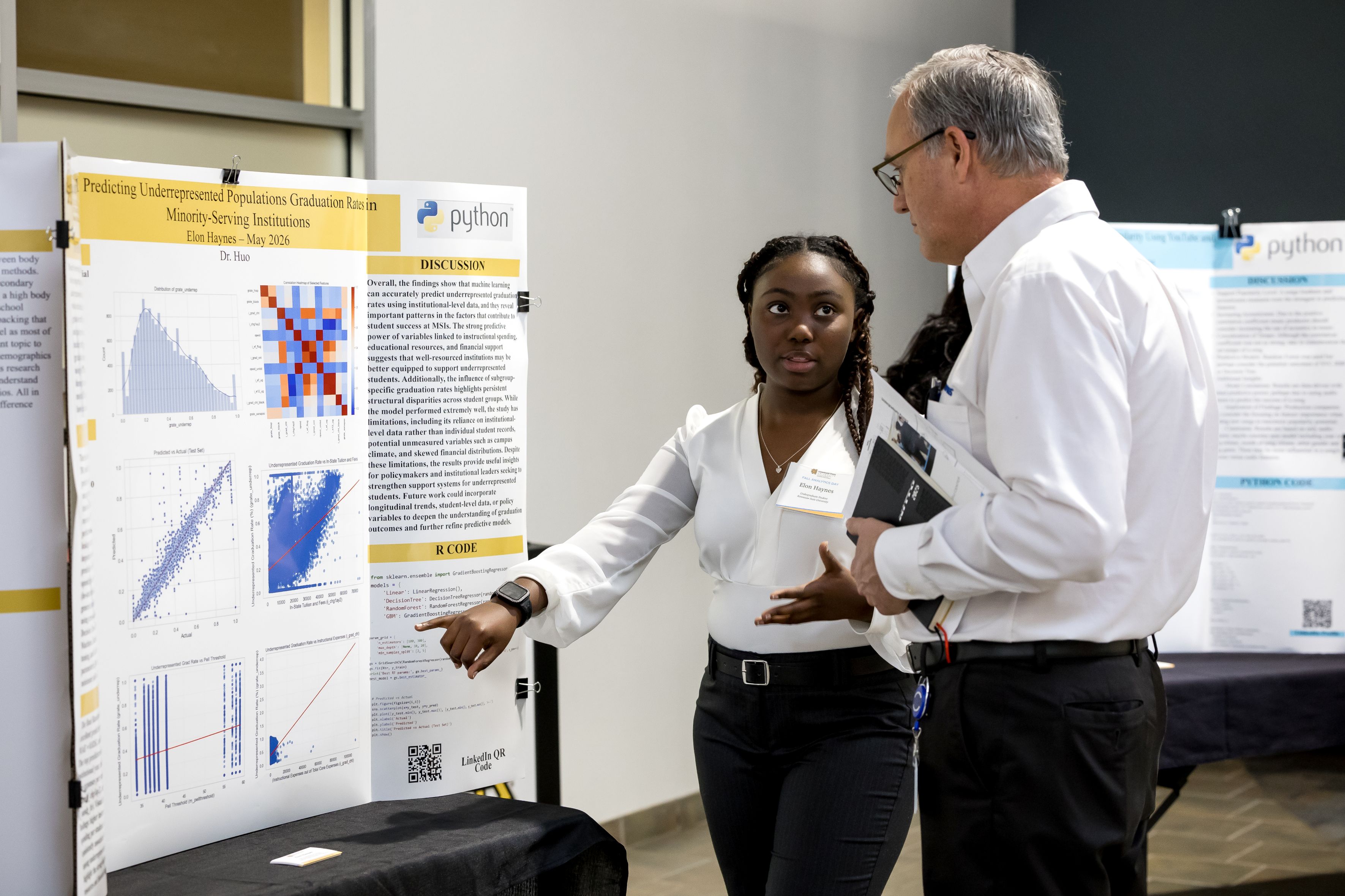 A student explains her poster to a conference attendee