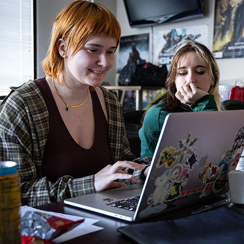 Two female students looking at a computer screen.