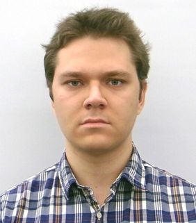 man looking ahead with blue and white shirt