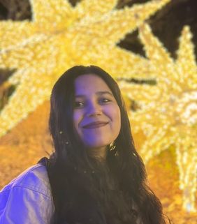 woman smiling with gold stars behind her