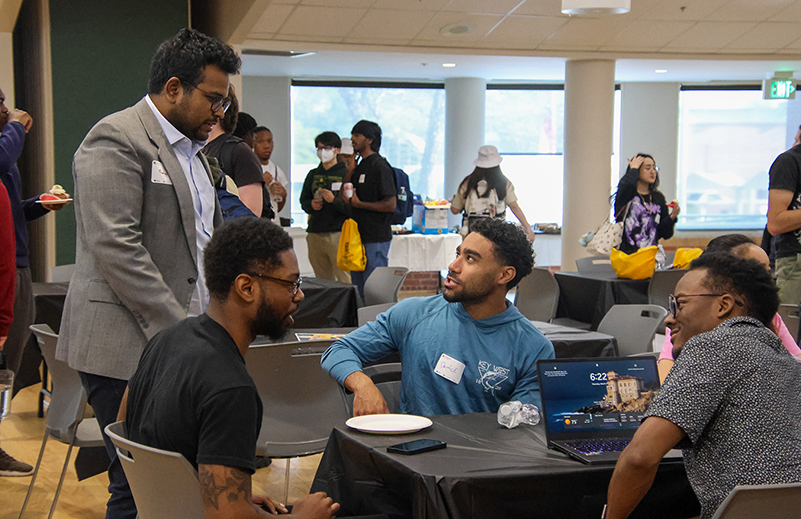 Students and mentors chat during the Spring Hackathon for Social Good