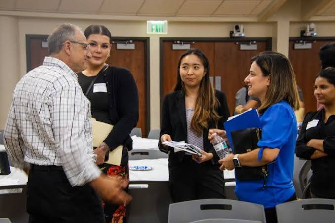 Darin Marrow is talking with student participants at the Employer Networking Night event.