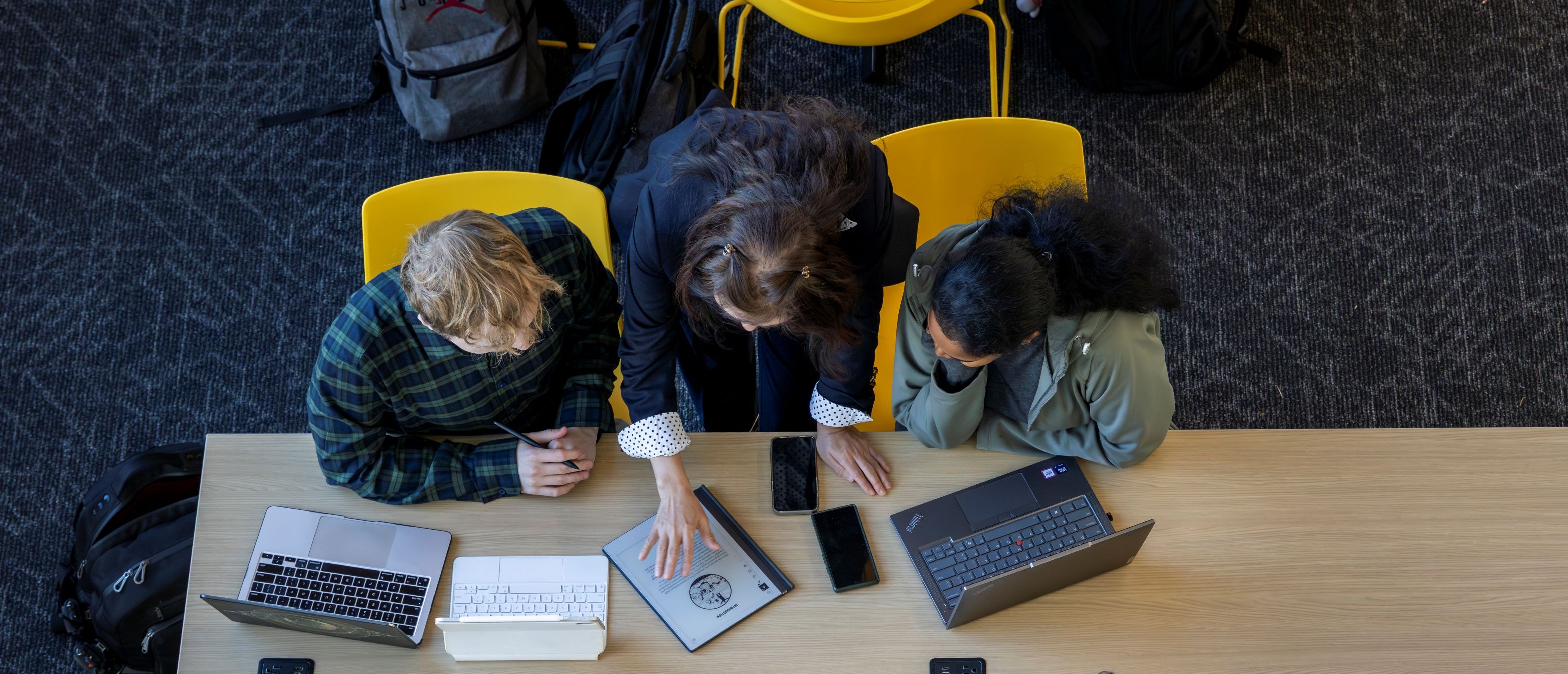 Overhead shot of professor and students working at table