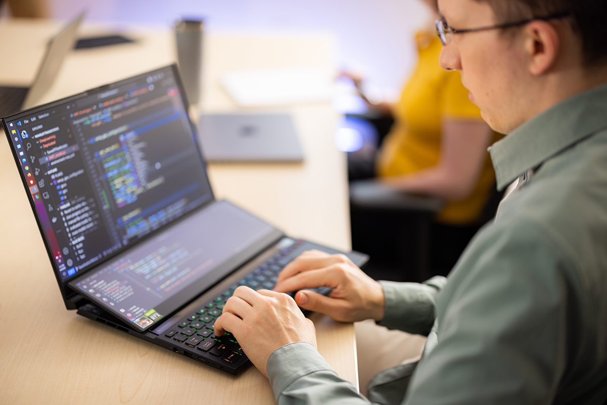 A student works at a laptop.