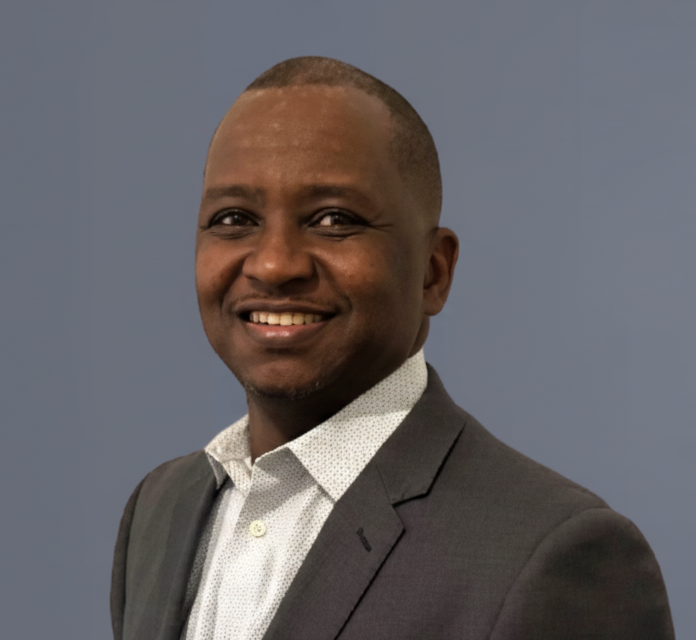 George Kinyua smiling at camera