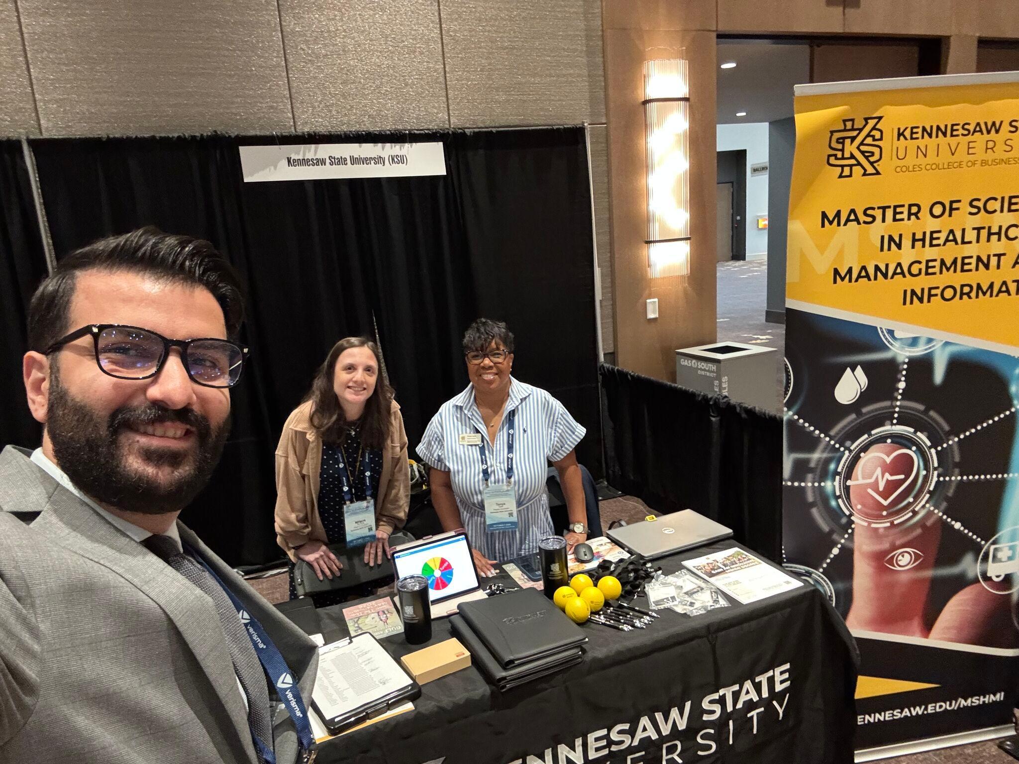  / Kennesaw State University exhibit table with program materials and banner at a conference booth