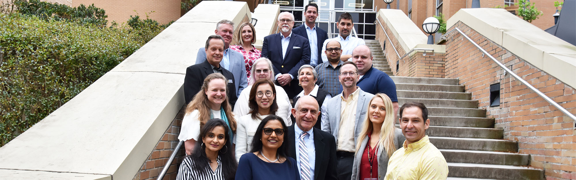 faculty of the marketing and professional sales department in front of the Burrus Building