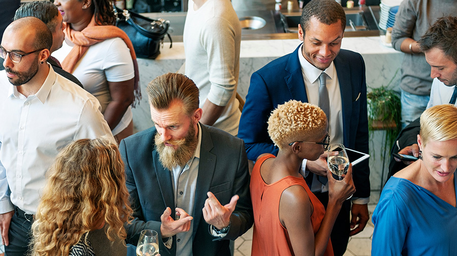 a group of people dressed in business casual at a social gathering