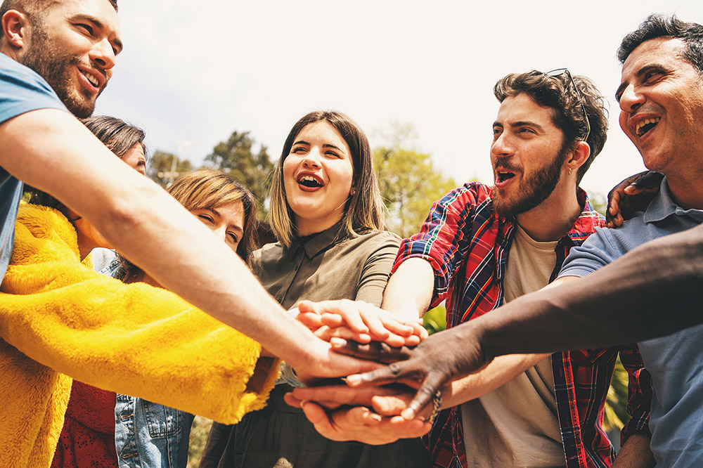 a group of people in a collective high five