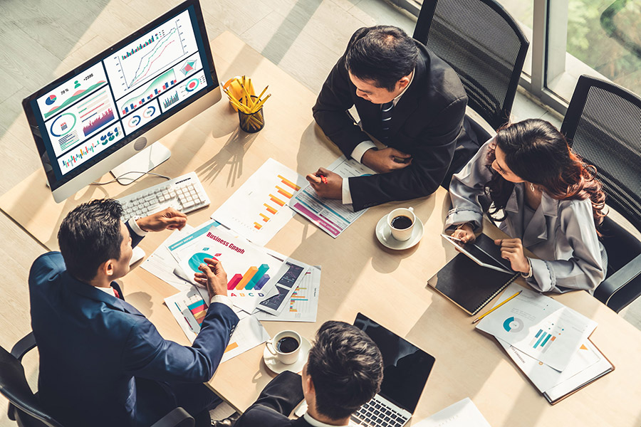 four people working at a conferance table