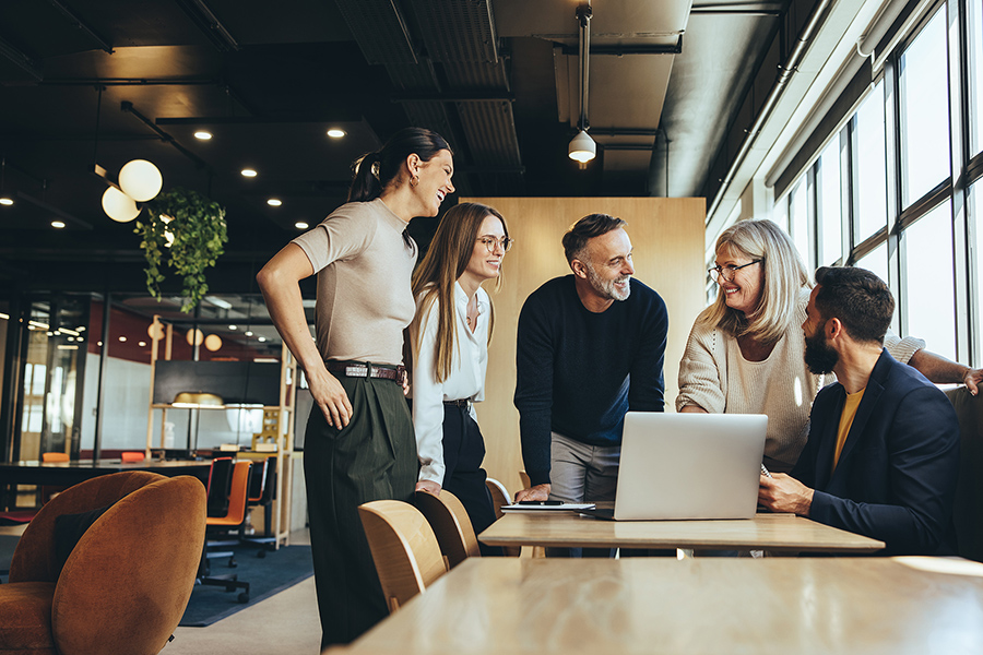five people are working together in a casual business setting