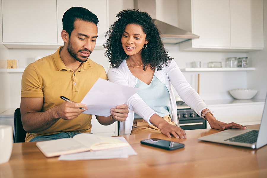 A couple working together at their kitchen table.
